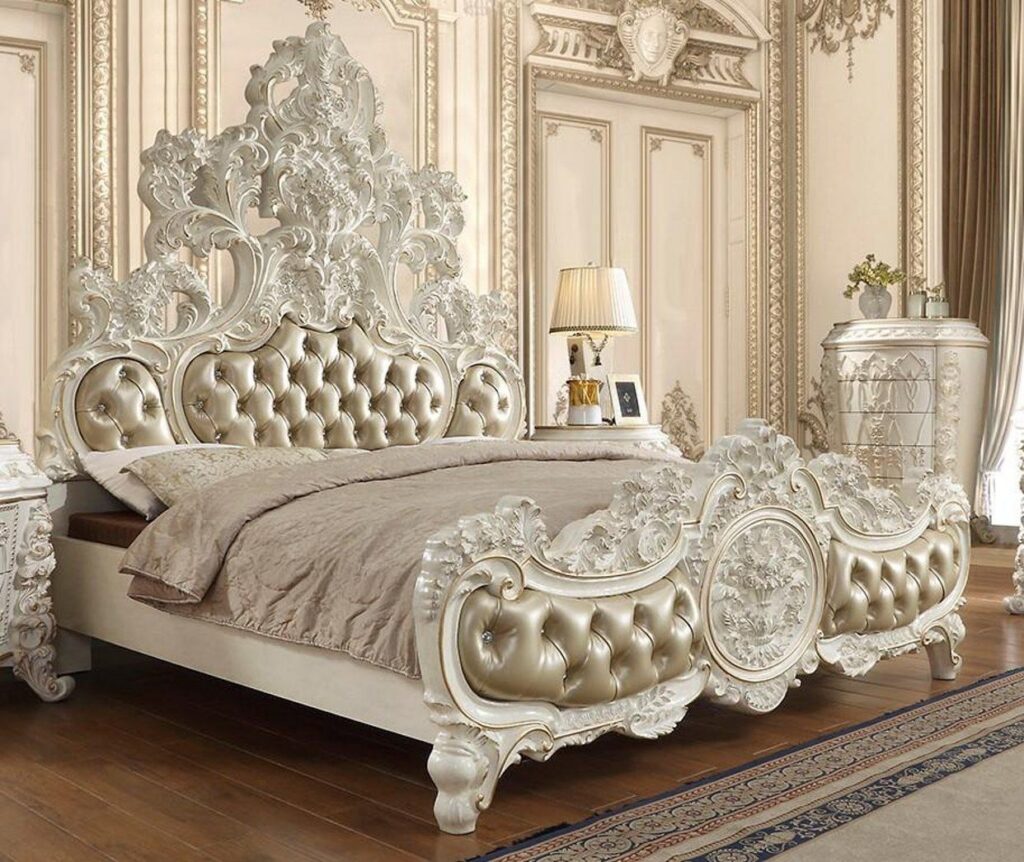 Luxurious baroque-style bed with ornate carvings and gold leather upholstery.